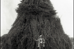 Mr-Crowfoot-with-the-king-sized-Pyramid-of-Faggots-built-on-the-green-for-the-bonfire-celebrations-of-the-Coronation-of-King-George-5th