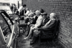Spectators-sitting-by-the-wall-of-the-Trinity-Hospital-at-a-Silver-Band-concert-on-the-Top-Green-Long-Melford-early-1970_s